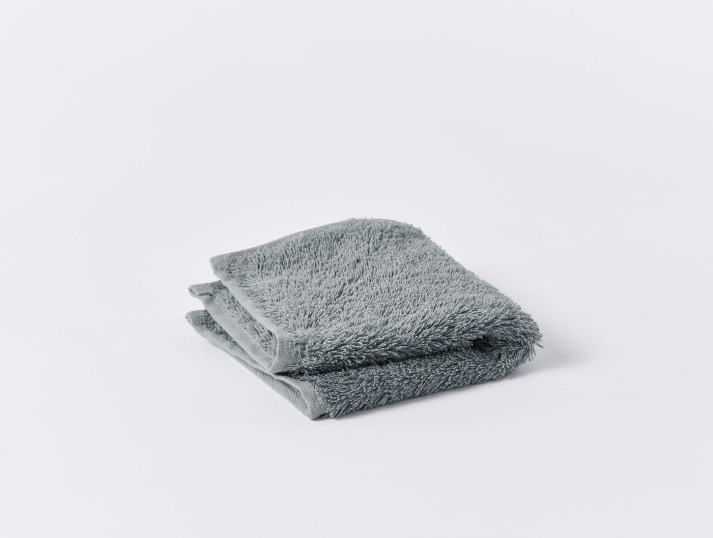 Folded slate grey terry cloth washcloth with plush, dense pile texture.
