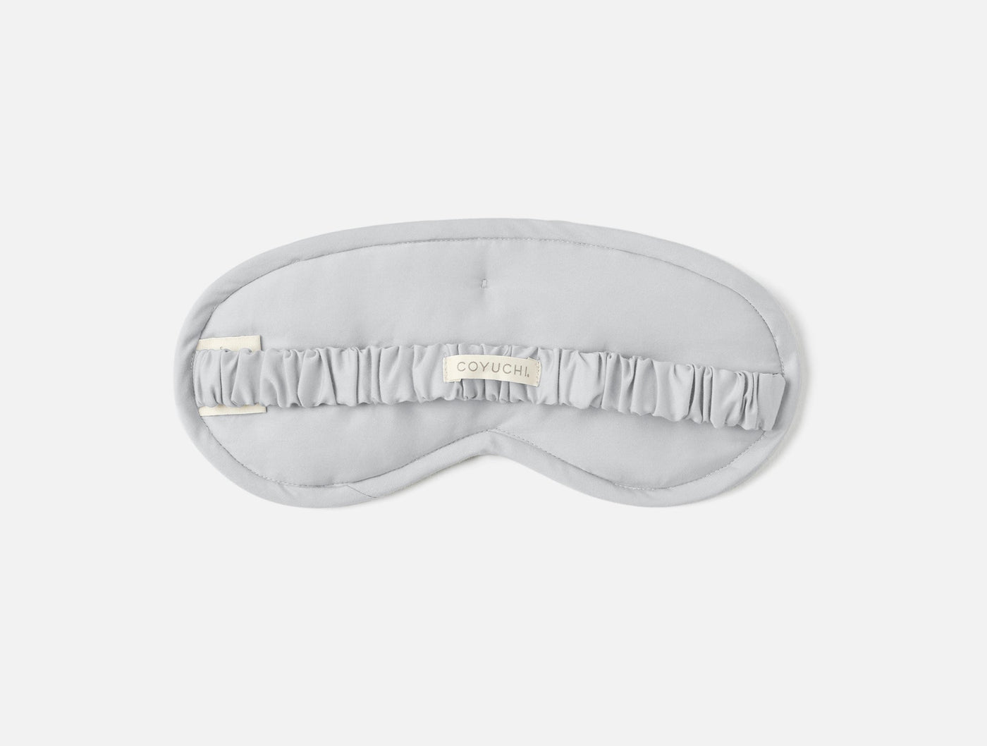 Coyuchi Cloud Soft Sateen eye mask in silver, ruffled center band detail, flat lay view.