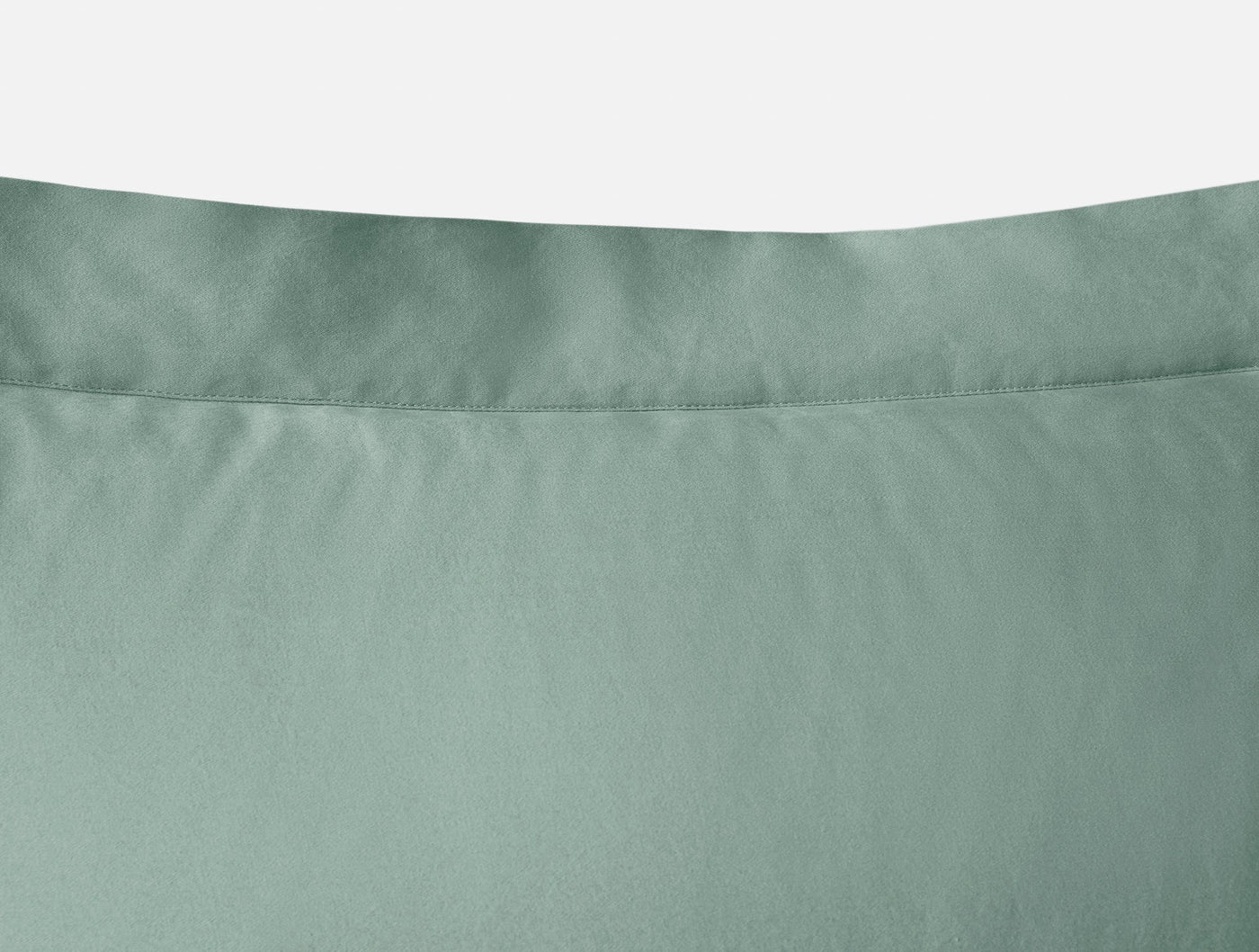 Close-up of Coyuchi Cloud Soft Sateen pillow sham hem detail in sage green.
