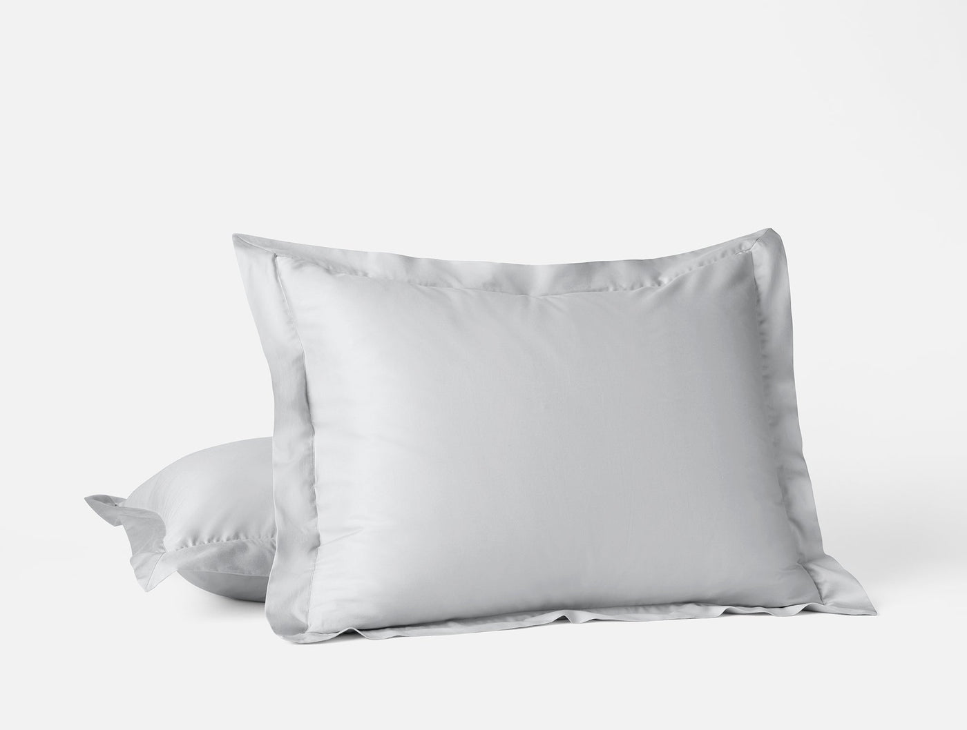 Two Coyuchi Cloud Soft Sateen pillow shams in silver stacked against white background.