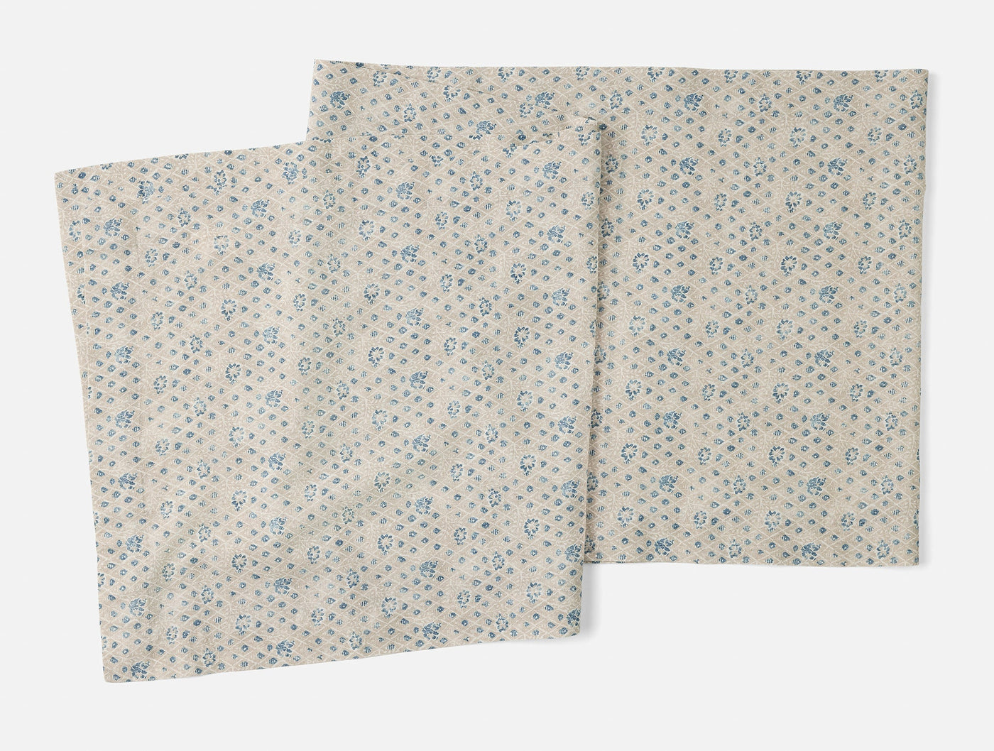 Coyuchi Coral Bell Print table runner in ivory with scattered blue floral pattern, two runners shown.