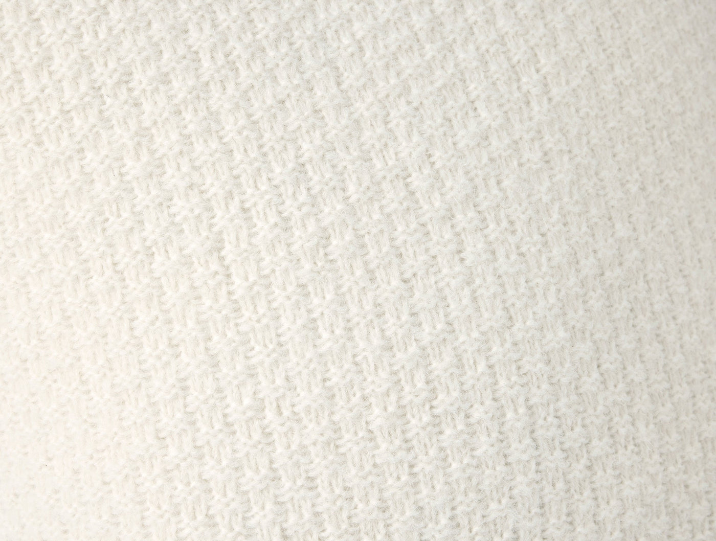 Close-up of ivory alpaca cotton knit weave texture on Cordillera pillow cover.
