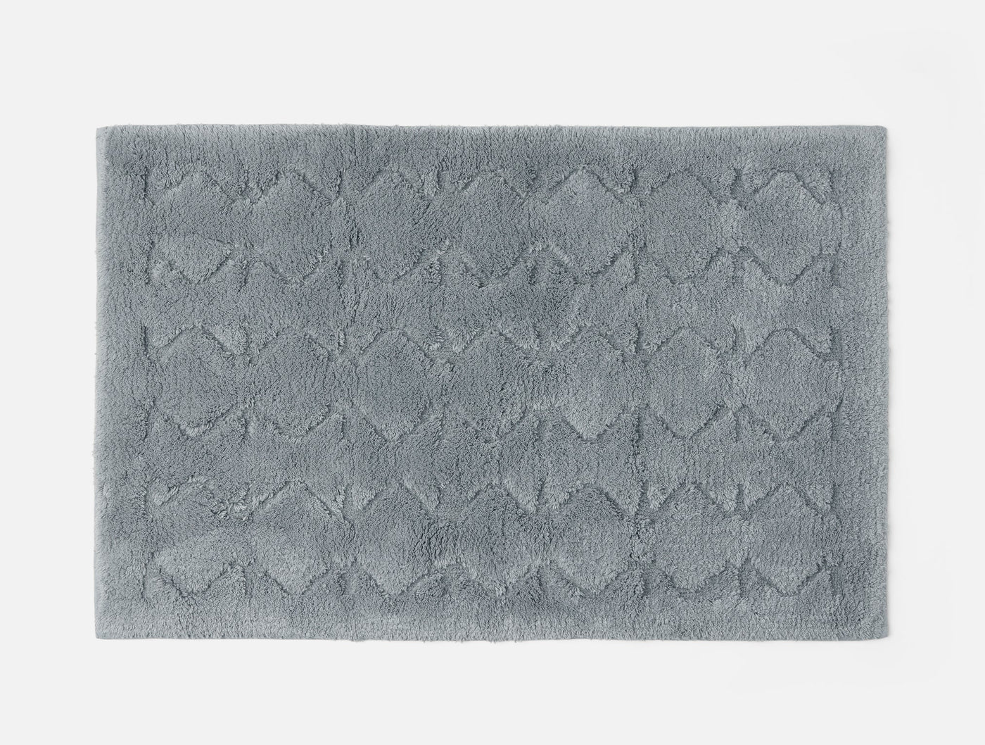 Coyuchi Diamond Shag runner in slate blue, close-up of tufted diamond pattern texture.