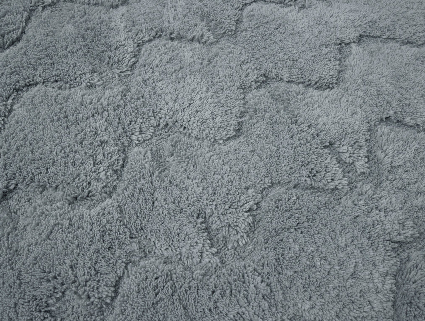 Close-up of Coyuchi Diamond Shag bath rug in slate, showing raised diamond loop pile texture.