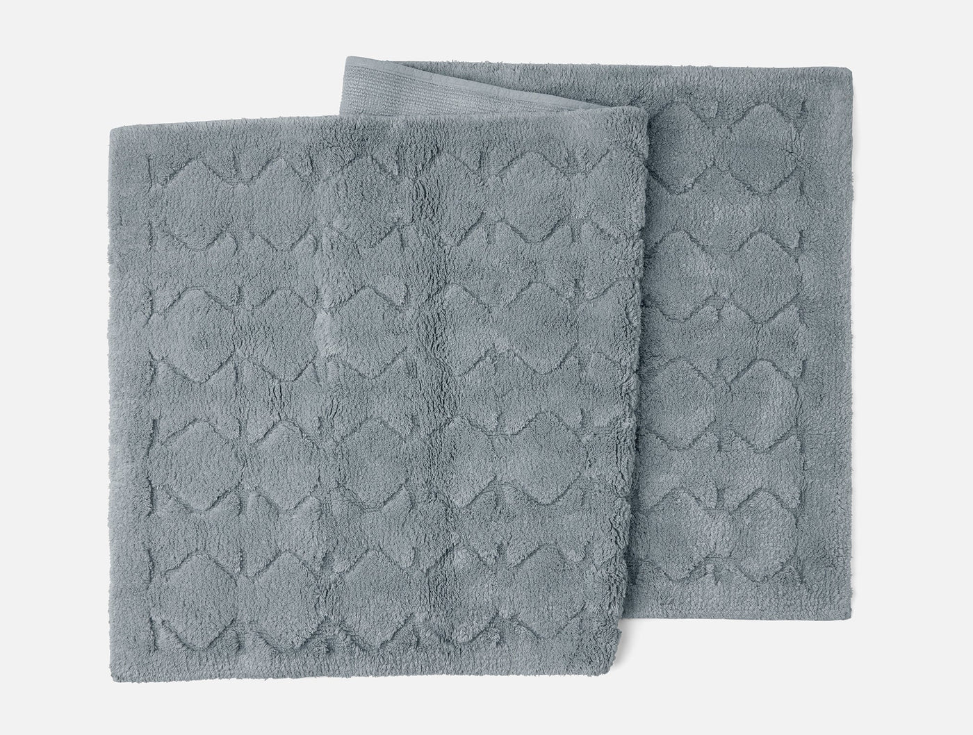 Two slate Coyuchi Diamond Shag runners stacked, showing tufted diamond texture.