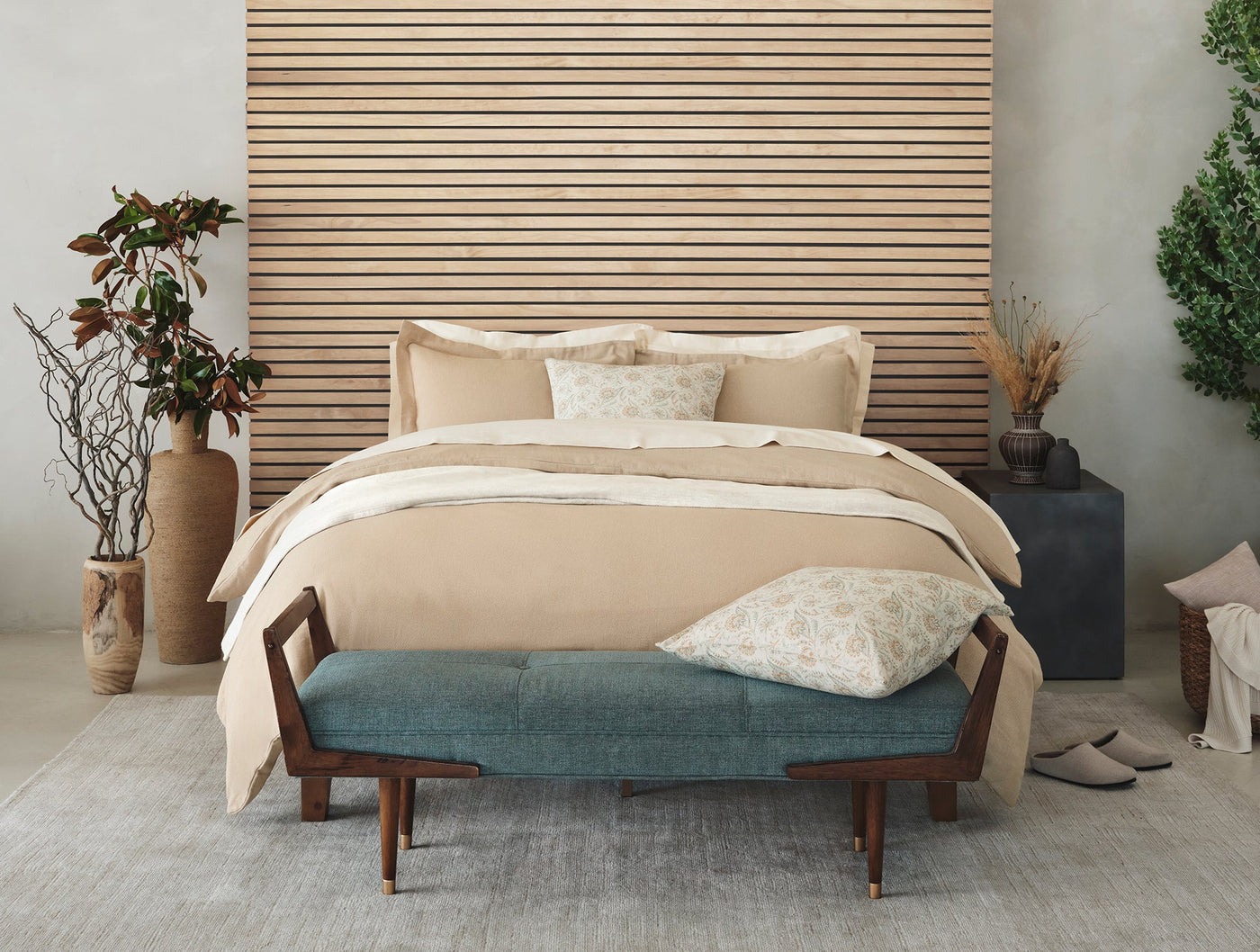 Coyuchi Cloud Brushed Flannel duvet cover styled on a bed in a warm neutral bedroom.
