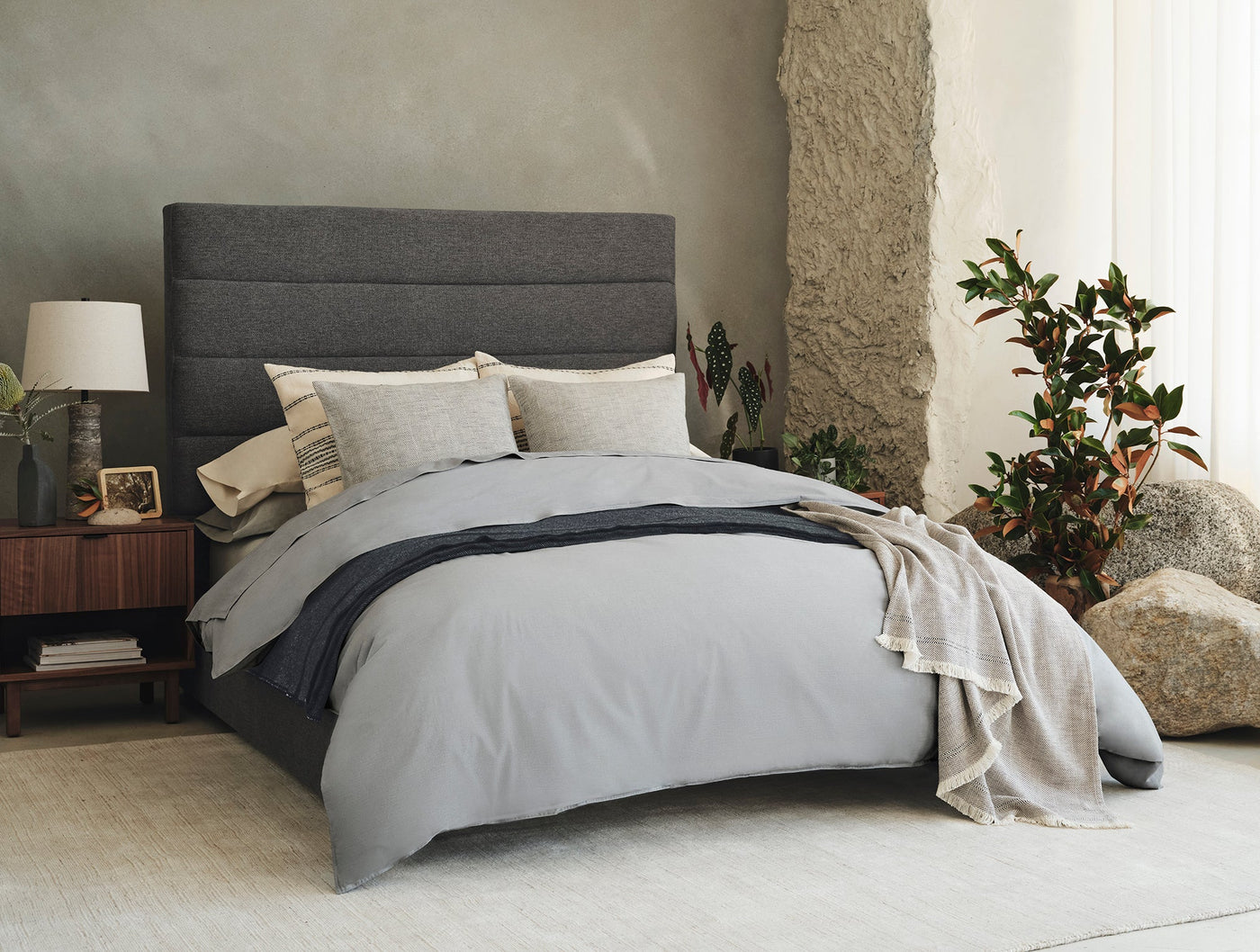 Styled bedroom showing silver Coyuchi Crinkled Percale shams layered with neutral bedding.