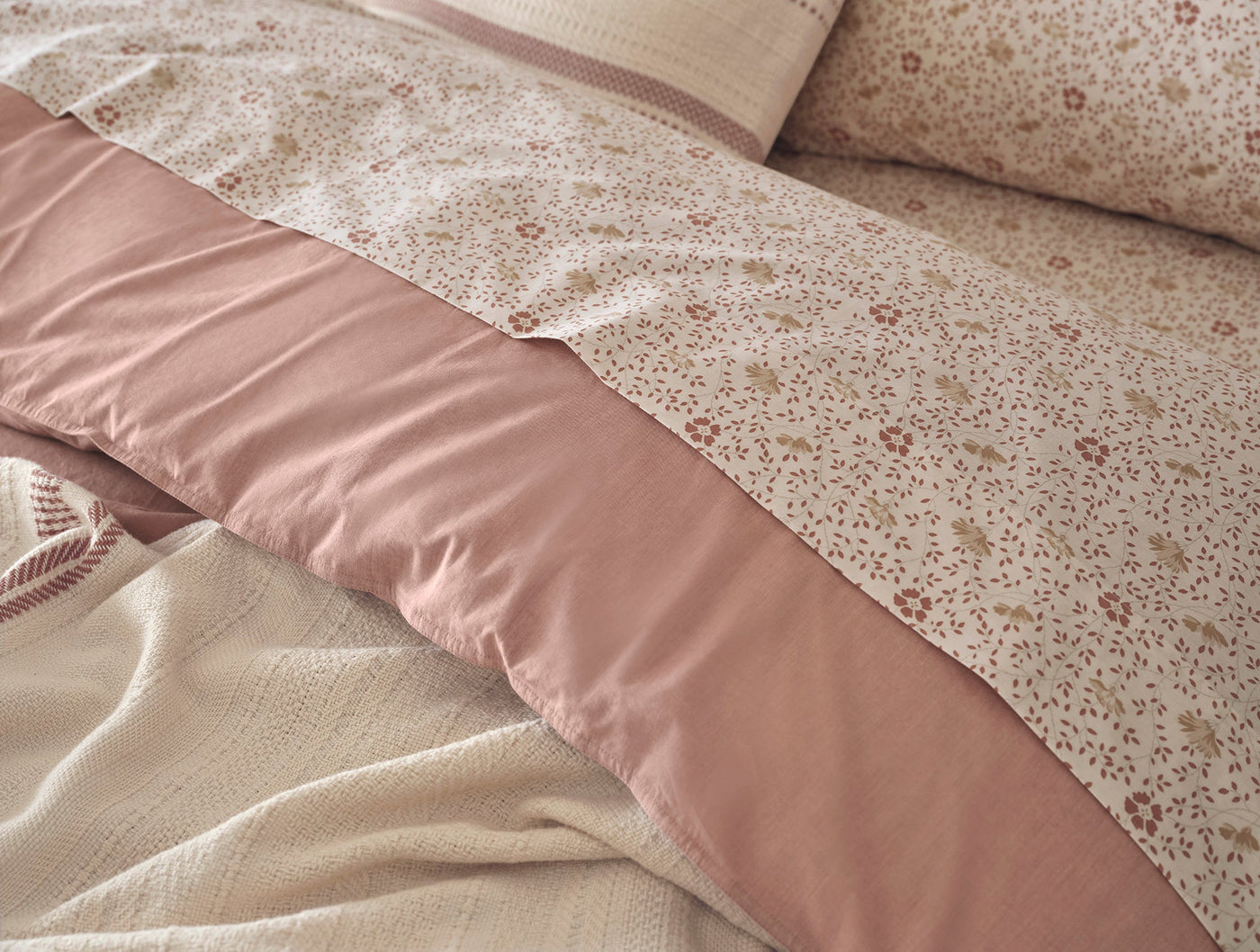 Close-up of dusty rose floral percale duvet cover with solid rose border panel detail.