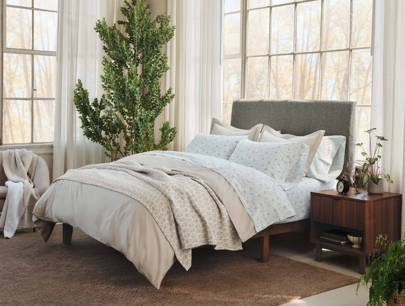 Bedroom scene with Coyuchi Print Percale sheet set in soft blue floral print on a styled bed.