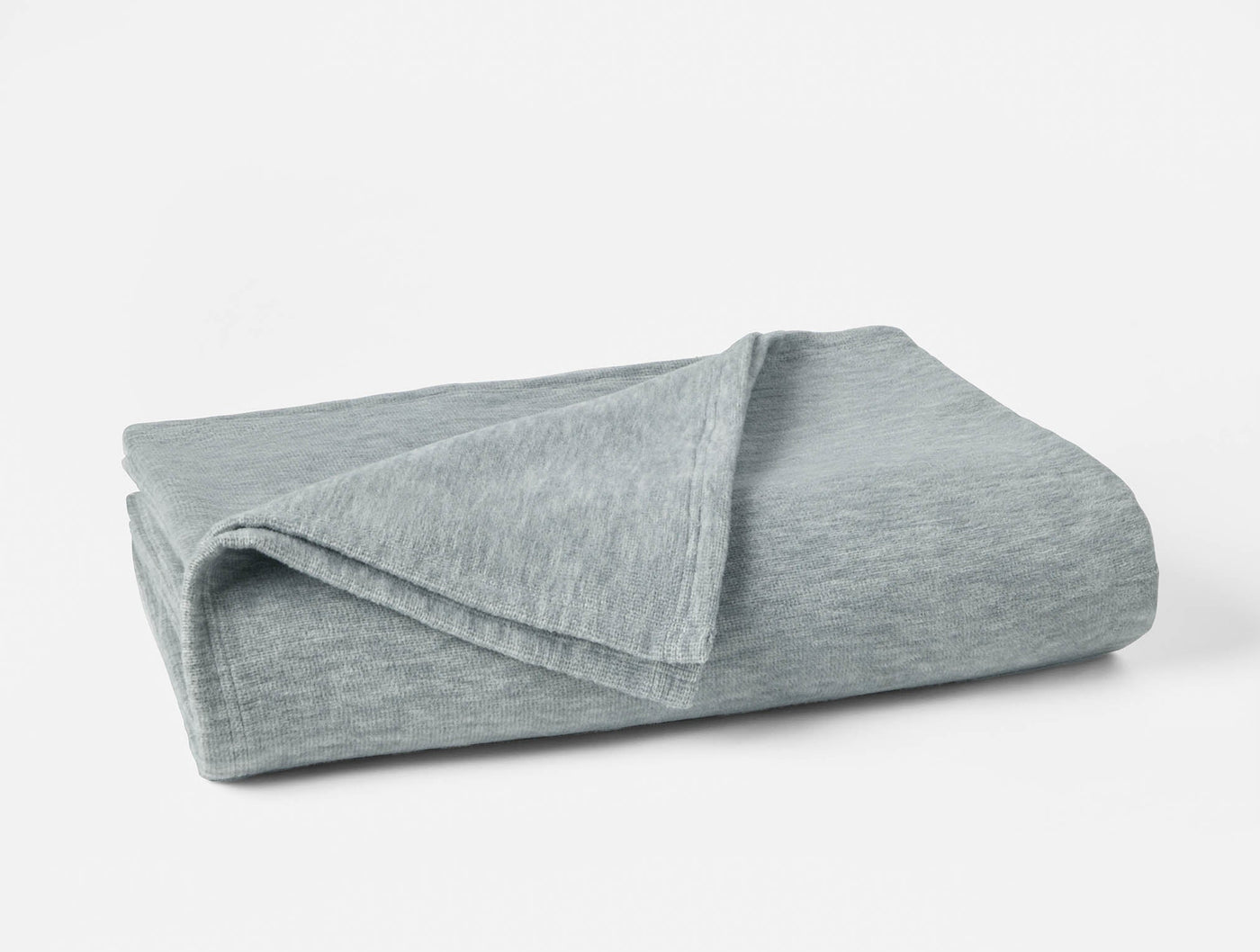 Coyuchi Full Circle Cotton blanket folded, heathered sage cotton knit texture.