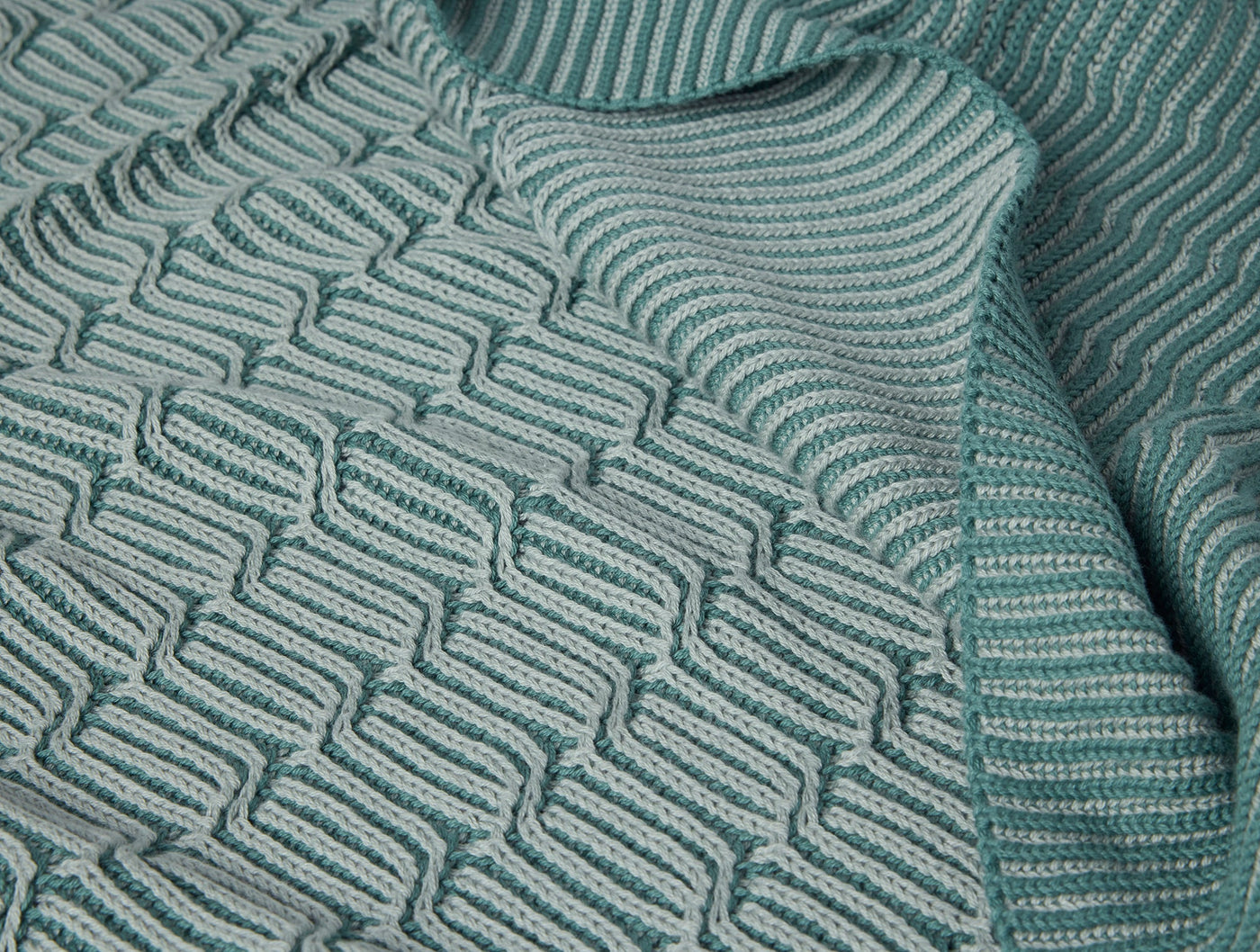 Close-up of Coyuchi Ivy Knit throw in seafoam, showing wave-textured cotton knit weave.