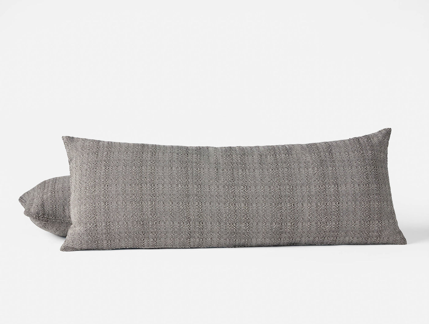 Coyuchi Lido pillow in charcoal heathered weave, body pillow with smaller accent pillow behind.