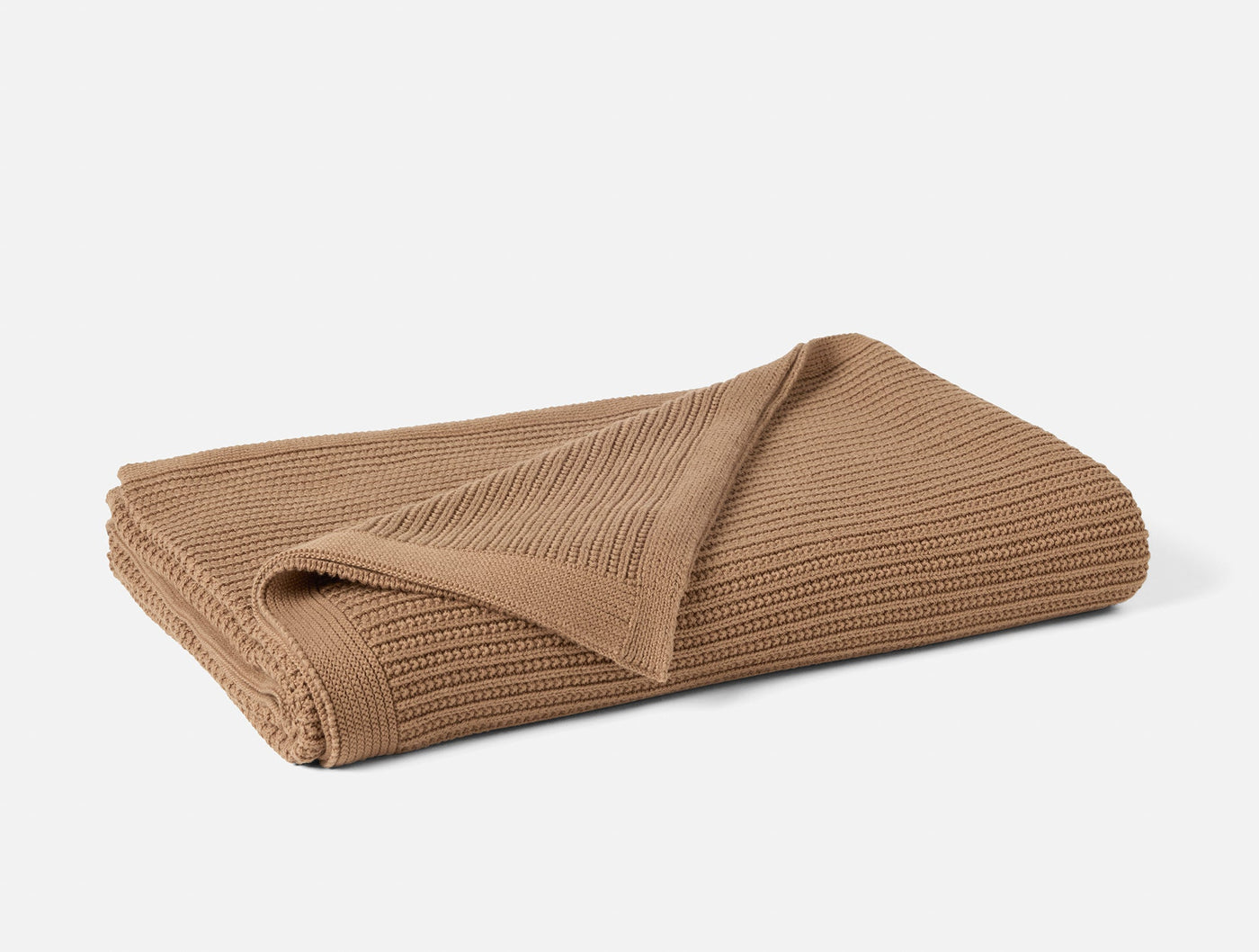 Coyuchi Linea Knit throw in camel, folded to show ribbed knit texture.