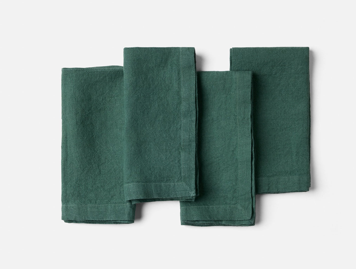Coyuchi Mojave Linen napkin set of four in forest green, flat lay view.