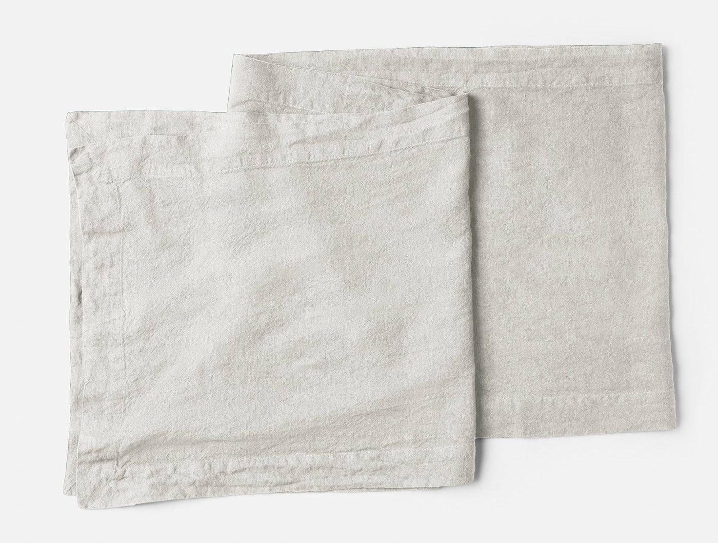 Coyuchi Mojave Linen napkins in natural, two folded squares showing relaxed texture.