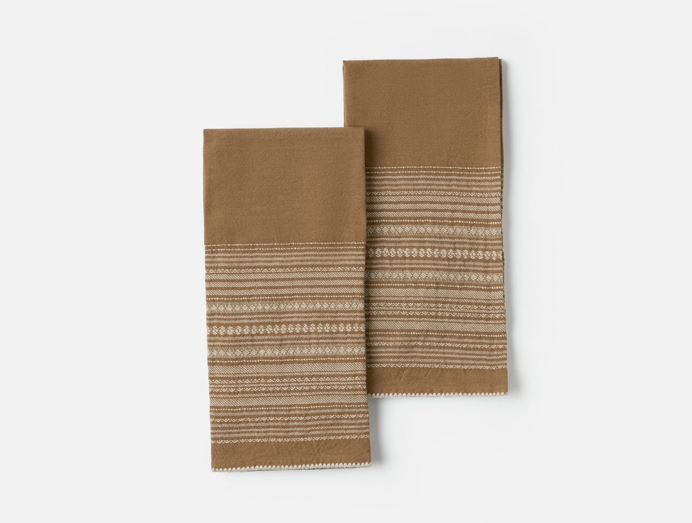 Coyuchi Oak hand towel pair in camel with woven stripe and dot border detail.
