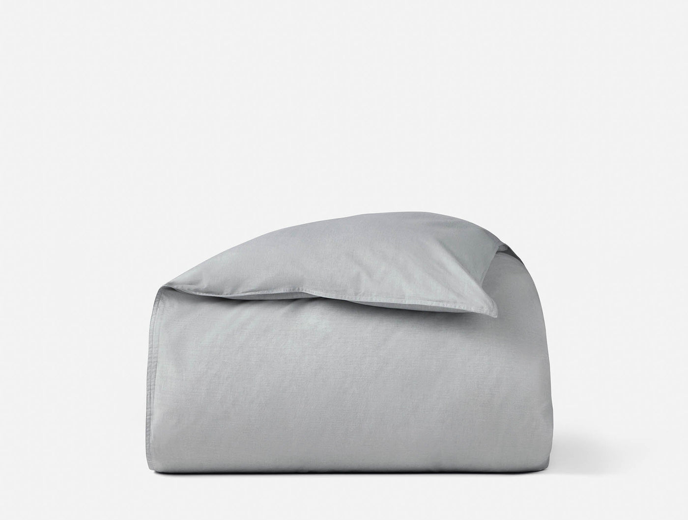 Coyuchi Crinkled Percale duvet cover folded with pillow in silver-grey.