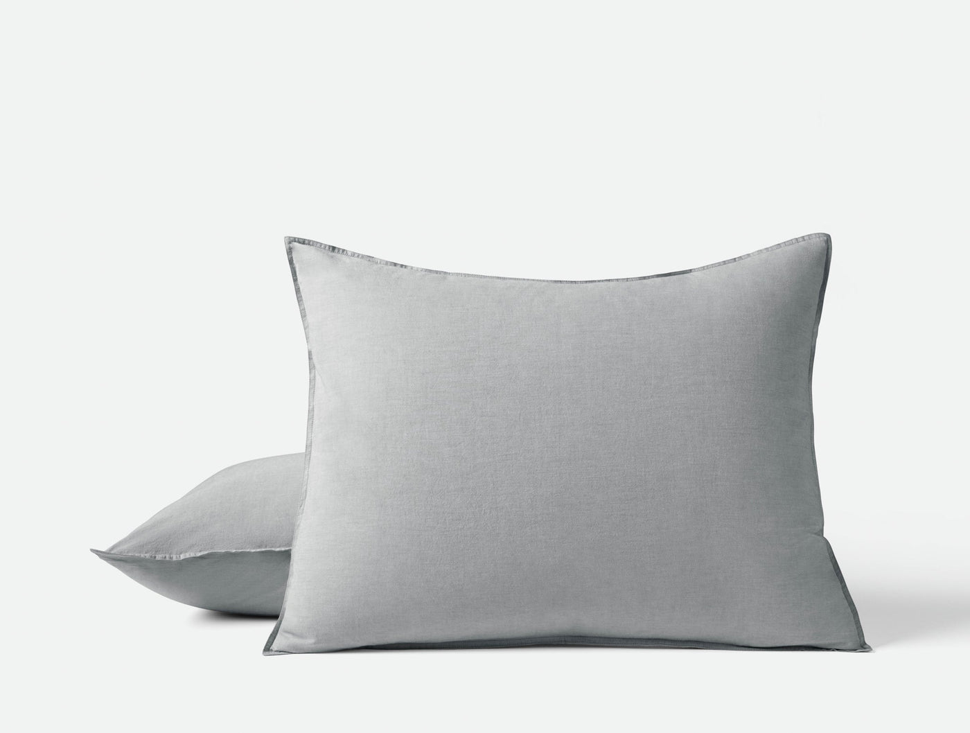 Two Coyuchi Crinkled Percale shams in mist gray, stacked against white background.