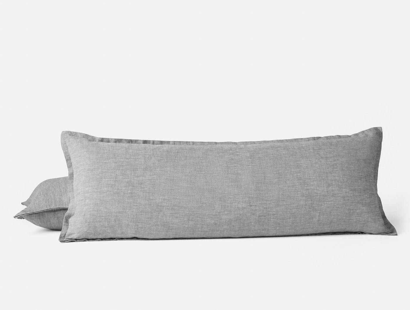 Coyuchi Relaxed Linen pillow covers in grey, lumbar and standard sizes stacked.