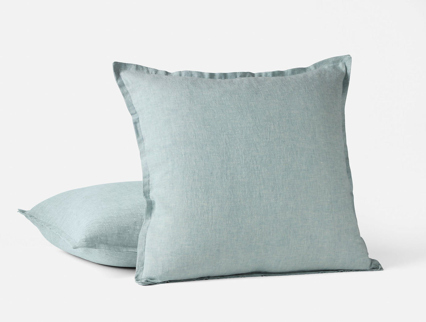 Pair of Coyuchi Relaxed Linen decorative pillows in mist blue with flange edge detail.