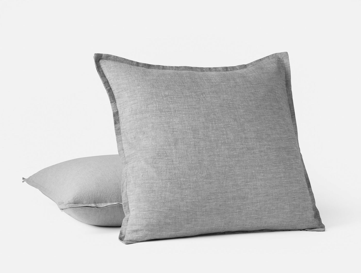 Coyuchi Relaxed Linen pillow in grey, showing frayed flange edge detail, pair stacked.