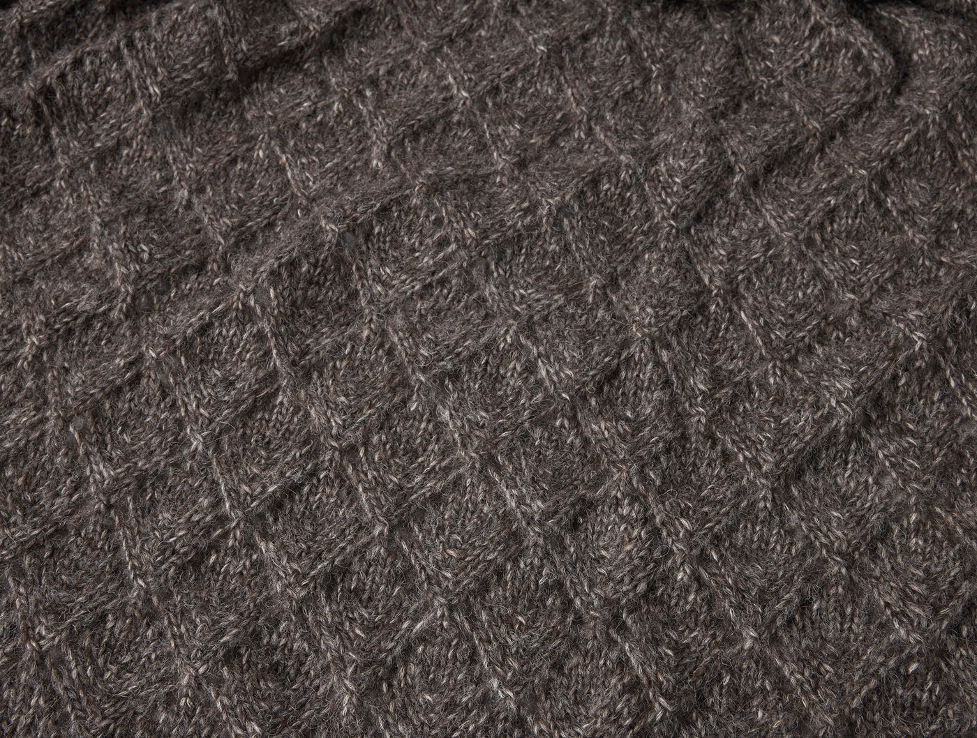 Close-up of Coyuchi Paracas throw's diamond knit texture in charcoal alpaca-cotton blend.