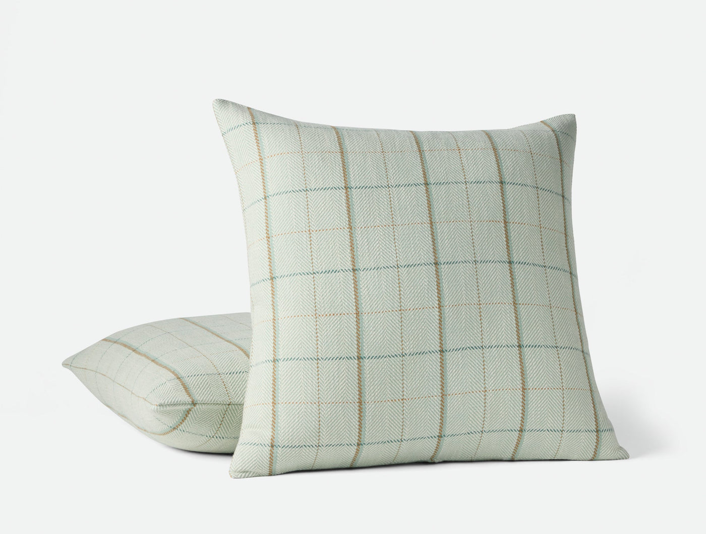 Coyuchi Paseo decorative pillow in sage green with woven grid plaid pattern, two sizes shown.