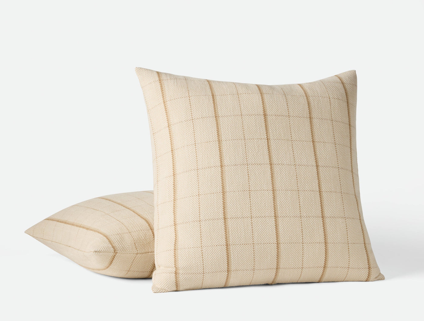 Coyuchi Paseo pillow covers in ivory, showing front and back views of woven grid pattern.