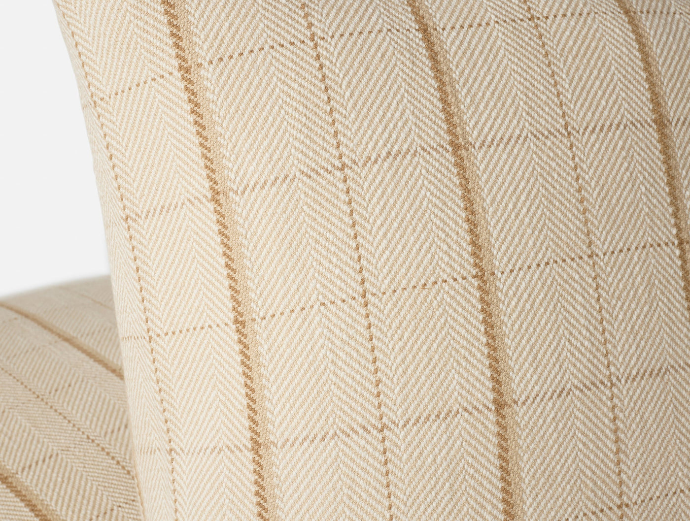 Close-up of Coyuchi Paseo pillow in ivory, showing herringbone weave with camel stripe detail.