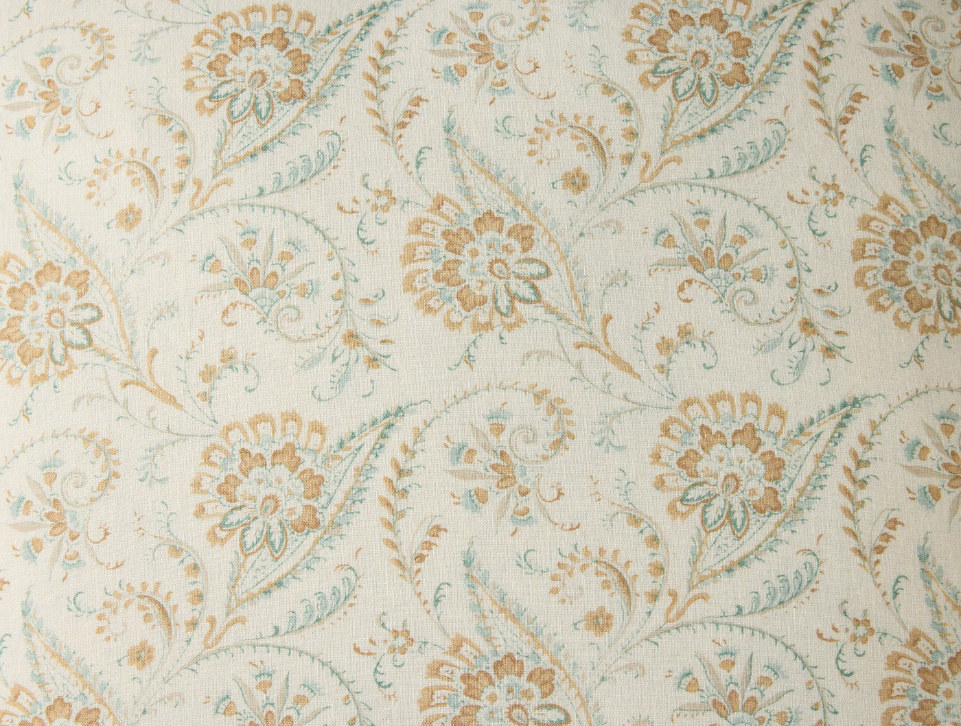 Close-up of Coyuchi Ponderosa Print pillow fabric, ivory with amber and sage floral motif.