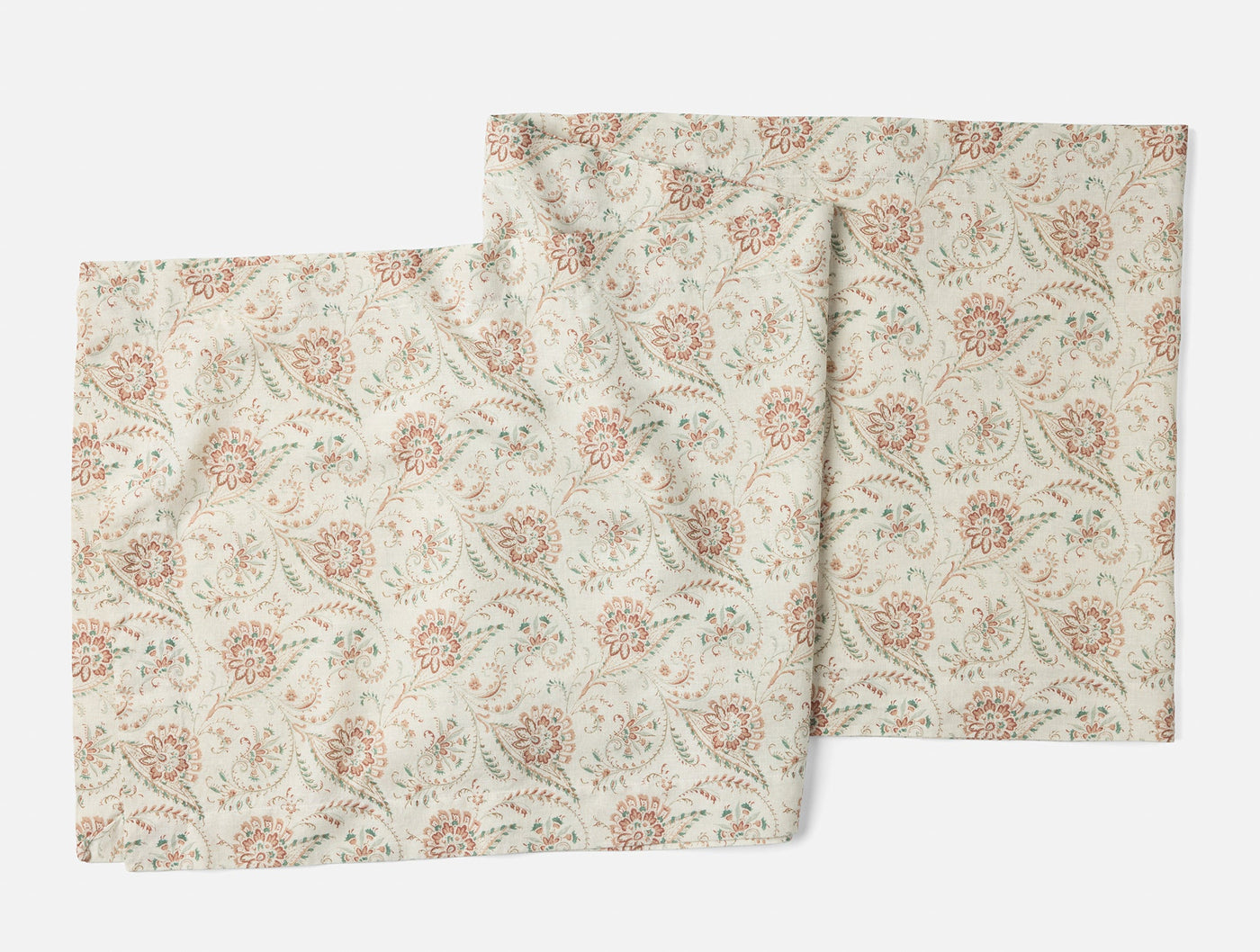 Pair of ivory Coyuchi Ponderosa table runners with dusty rose and sage floral print.