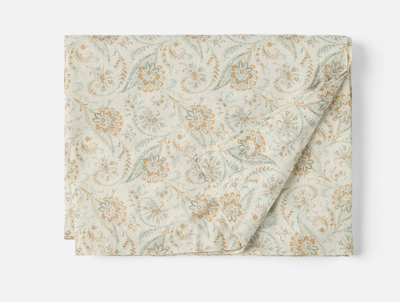 Coyuchi Ponderosa Print tablecloth in ivory with sage and amber floral print, folded flat.