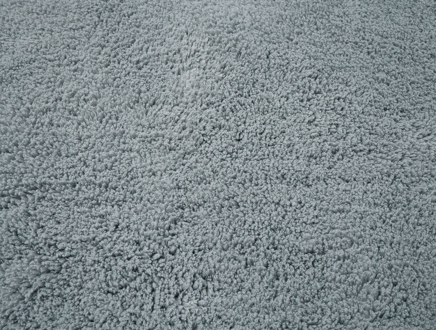 Close-up of Coyuchi Shag bath rug surface in slate blue, showing dense looped terry texture.