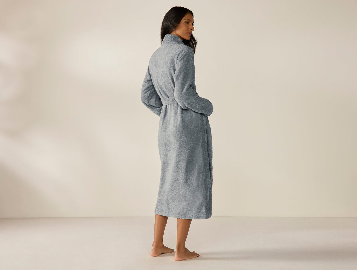 Back view of Coyuchi Cloud Loom robe in slate blue, floor-length terry with belted waist.