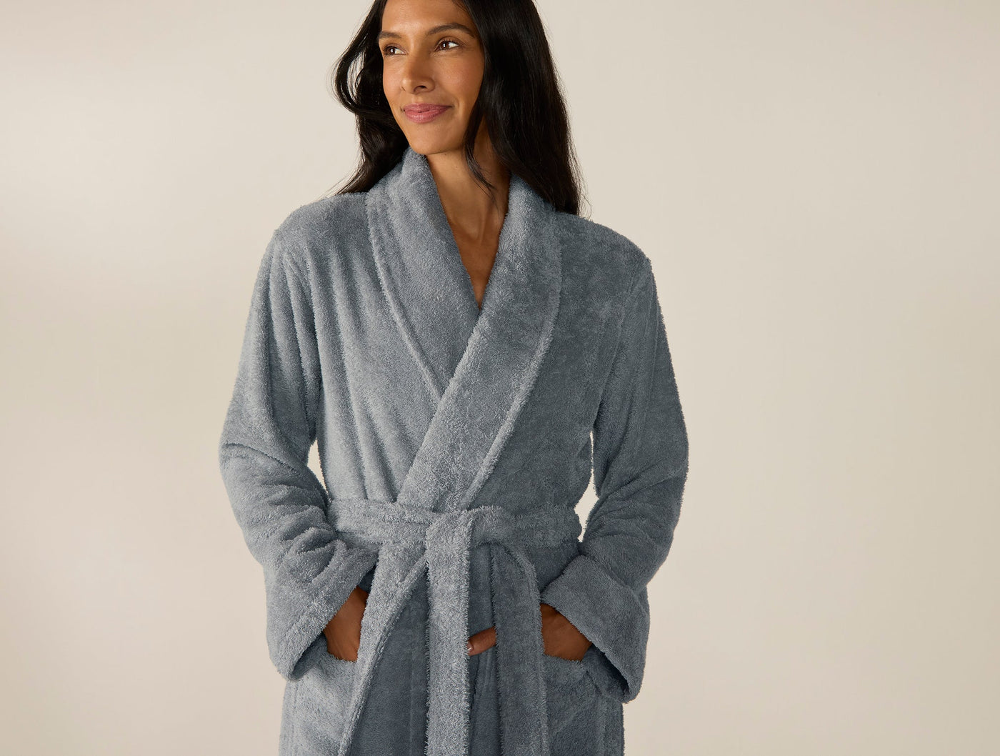 Coyuchi Cloud Loom robe in slate blue, worn and belted, showing shawl collar and plush terry texture.