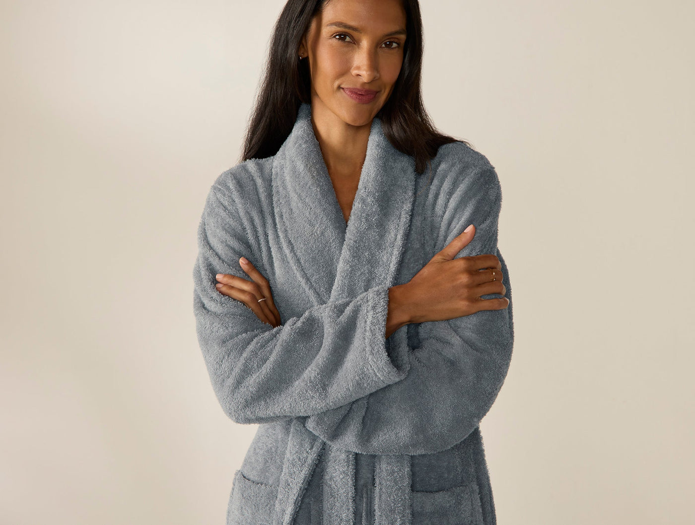 Close-up of Coyuchi Cloud Loom robe in slate blue, worn by model with arms crossed.