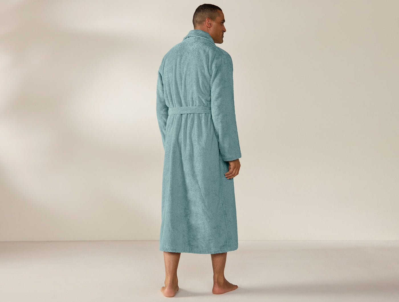 Back view of Coyuchi Cloud Loom robe in teal, full-length terry with belted waist.