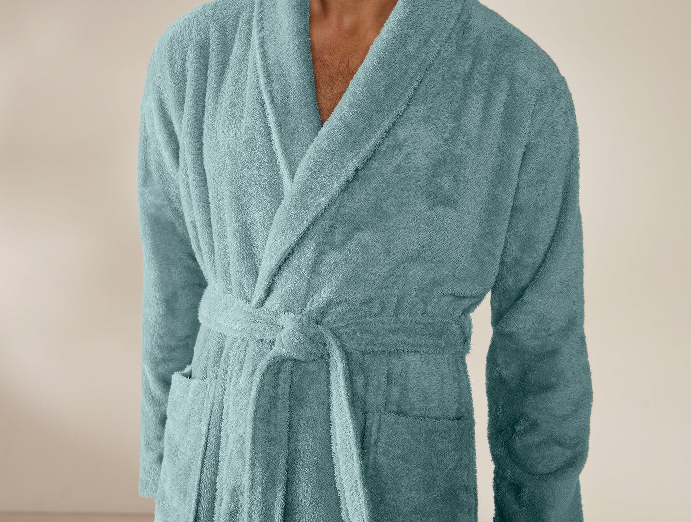 Close-up of Coyuchi Cloud Loom robe in teal, showing shawl collar and belted waist.