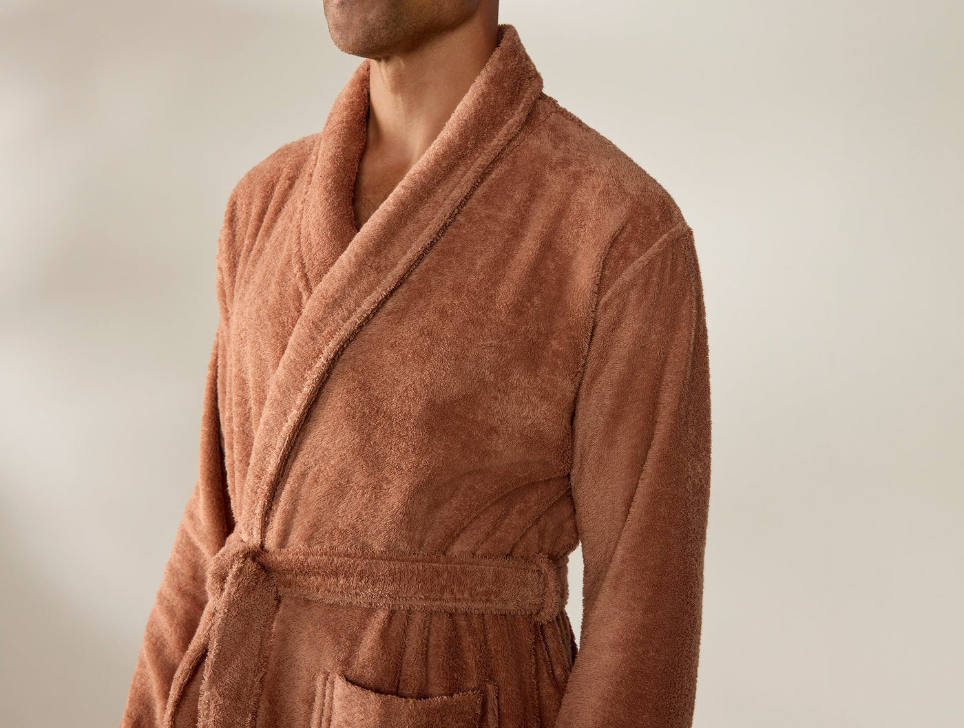 Close-up of Coyuchi Cloud Loom robe in terracotta, showing shawl collar and belted waist.