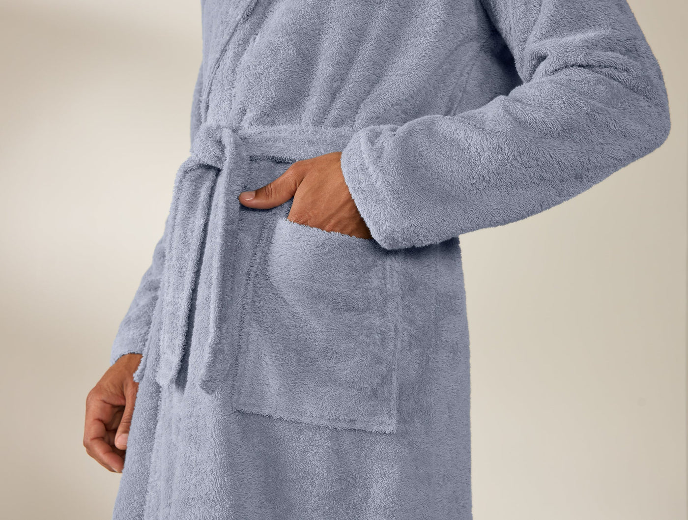 Close-up of periwinkle Coyuchi Cloud Loom robe pocket and tie belt detail.
