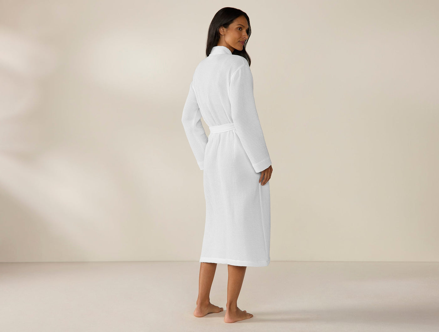 Back view of Coyuchi Unisex Waffle Robe in white, belted at waist, midi length.