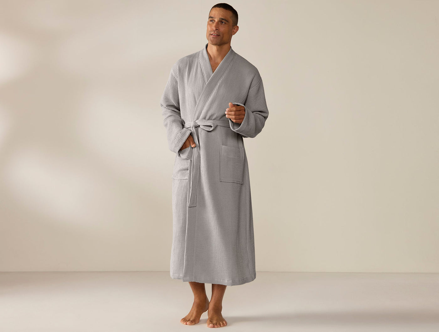 Coyuchi Unisex Waffle Robe in silver-grey, full-length view on male model.