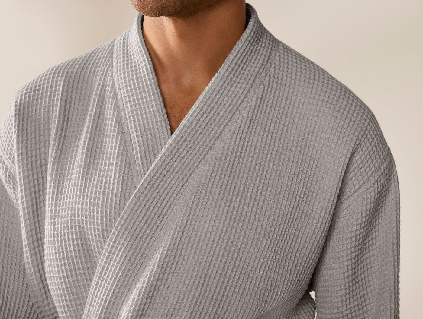 Close-up of Coyuchi waffle robe collar and chest in slate grey, showing textured weave detail.