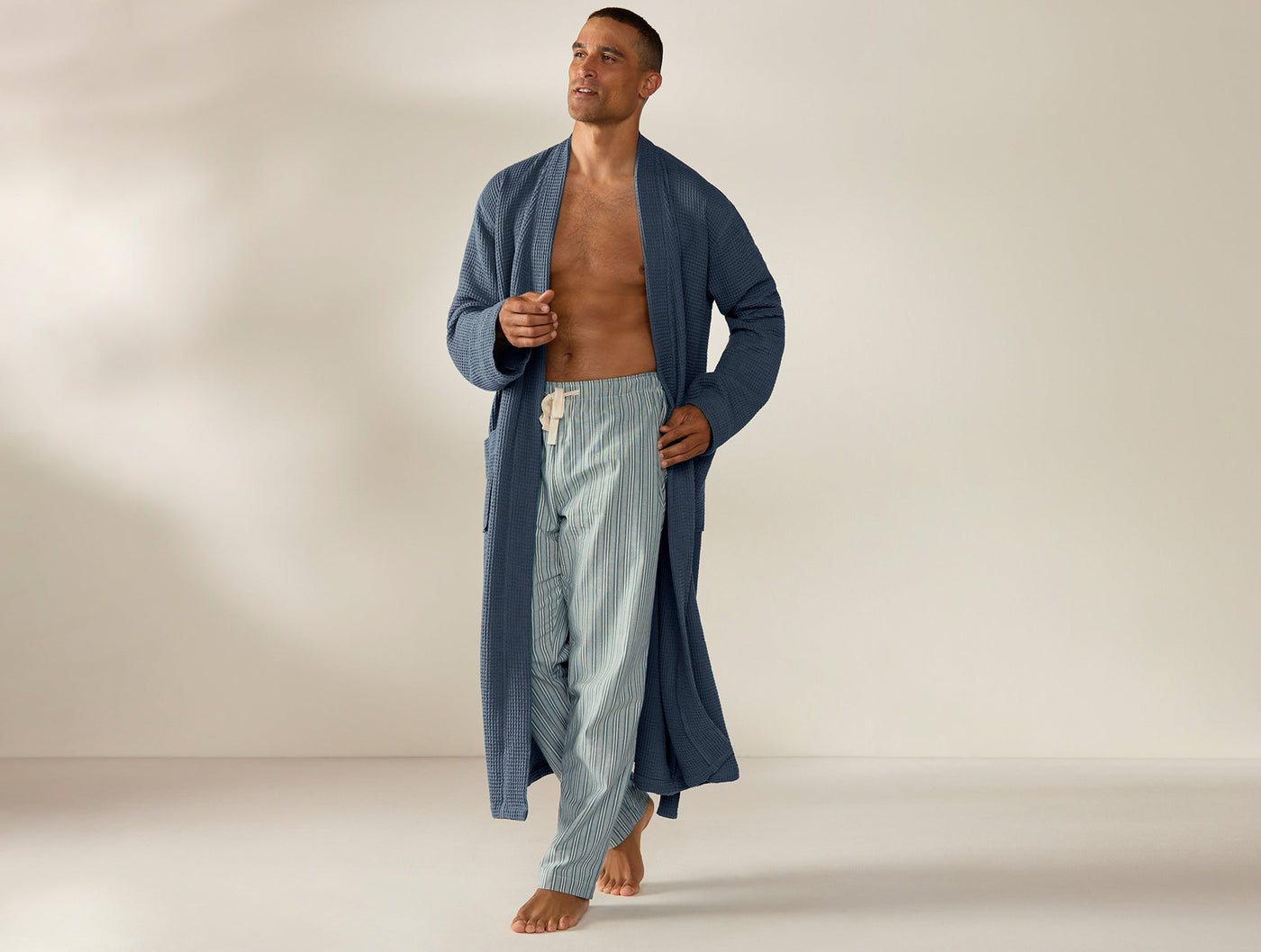 Coyuchi Unisex Waffle Robe in slate blue, full-length view on male model.