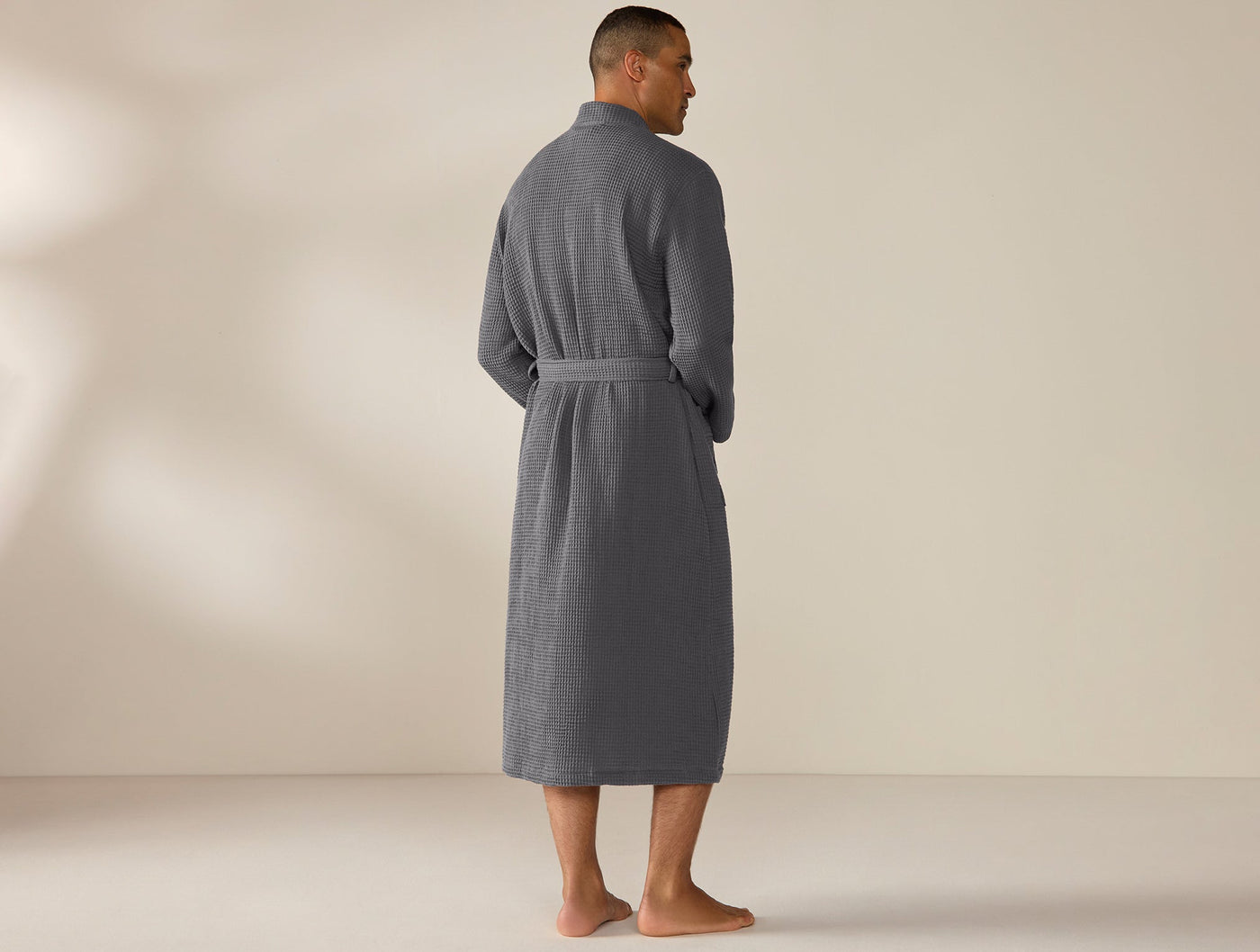 Back view of Coyuchi Unisex Waffle Robe in slate grey, full-length with tied belt.