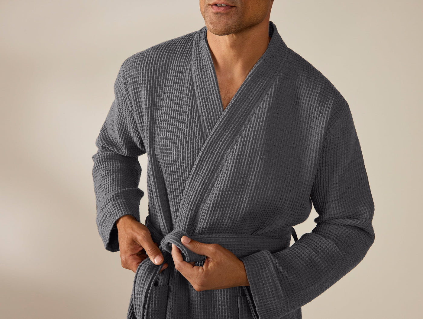 Close-up of Coyuchi waffle-knit robe in slate, showing kimono collar and tie belt.