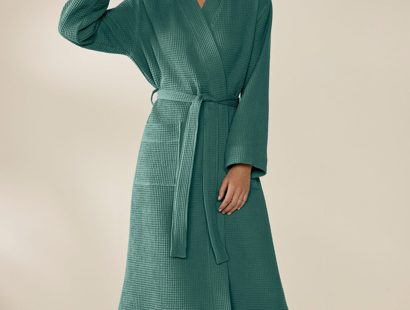 Teal waffle-knit robe with belted waist, shown from torso to hem on a model.