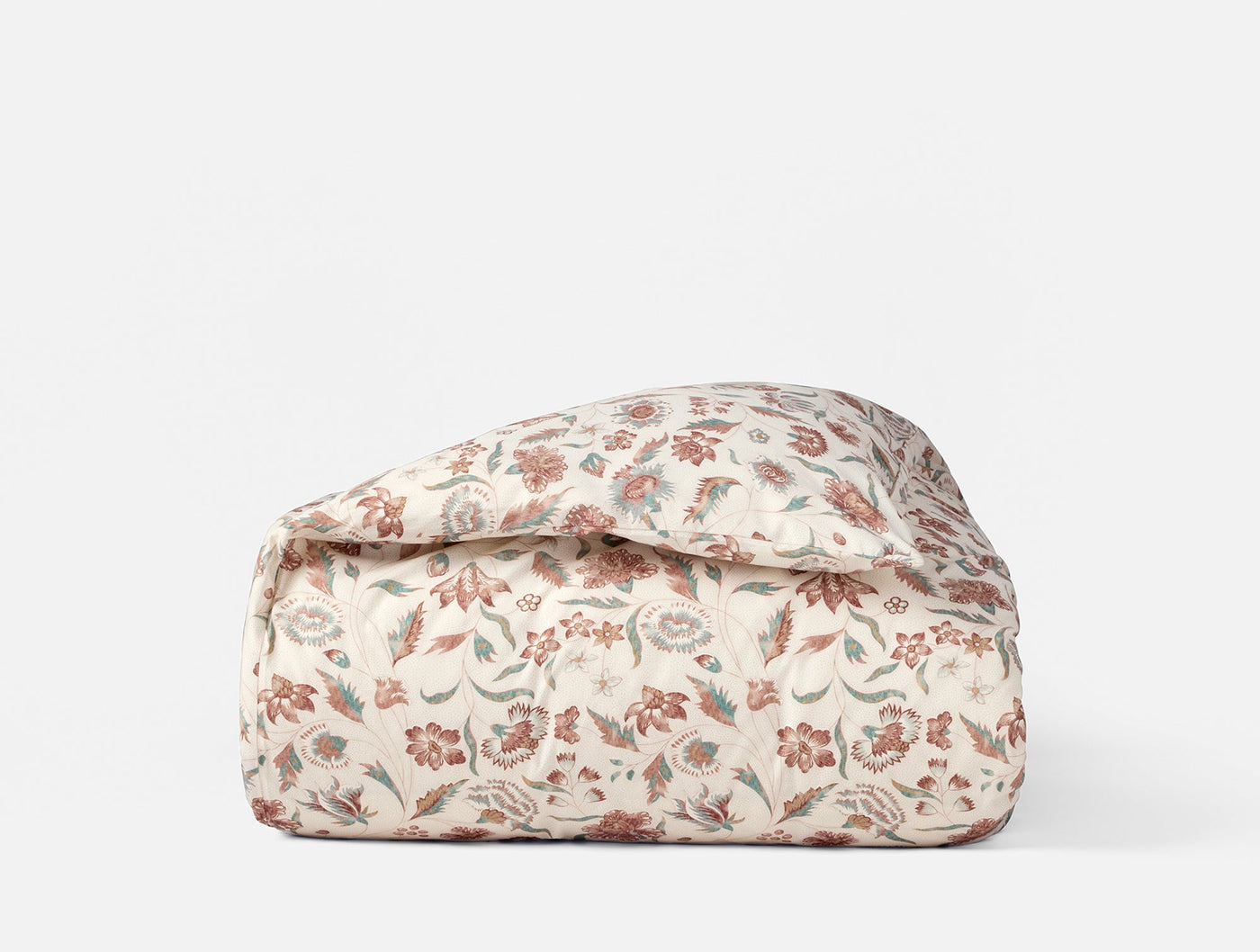 Coyuchi Viola Print duvet cover folded, ivory with red and sage floral pattern.