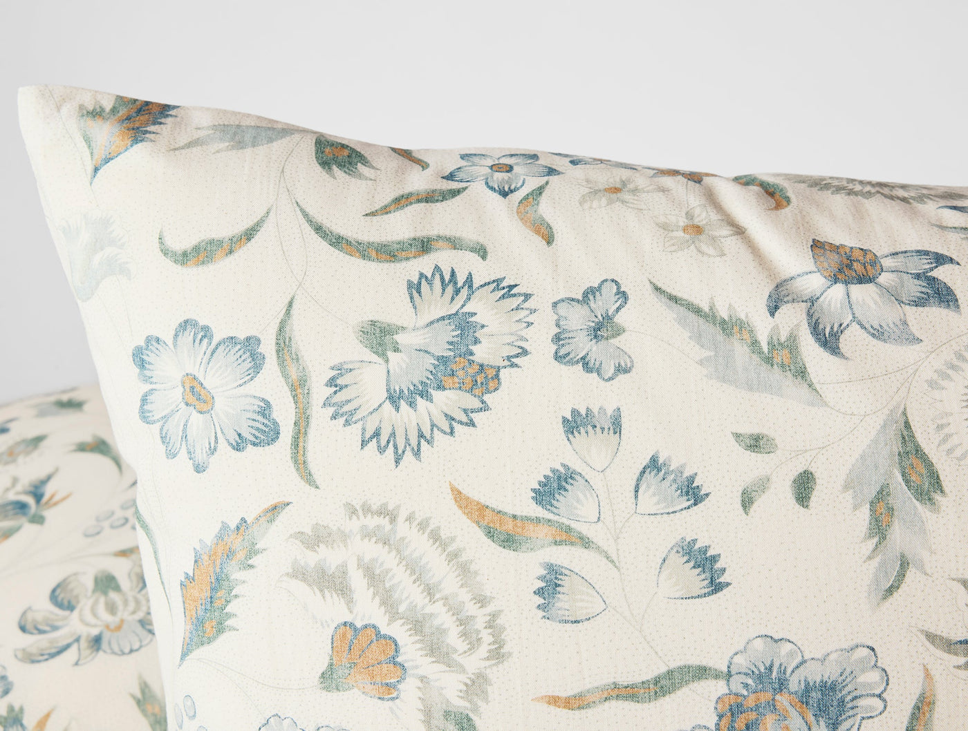 Close-up of Coyuchi Viola Print sham corner, ivory with blue and sage floral print.