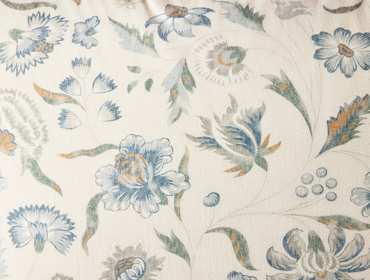 Close-up of Coyuchi Viola Print sham fabric, ivory ground with blue and amber botanical print.